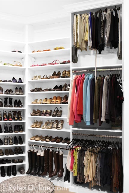 Airy Closet with Hanging Boot Storage and Pull Down Closet Rod