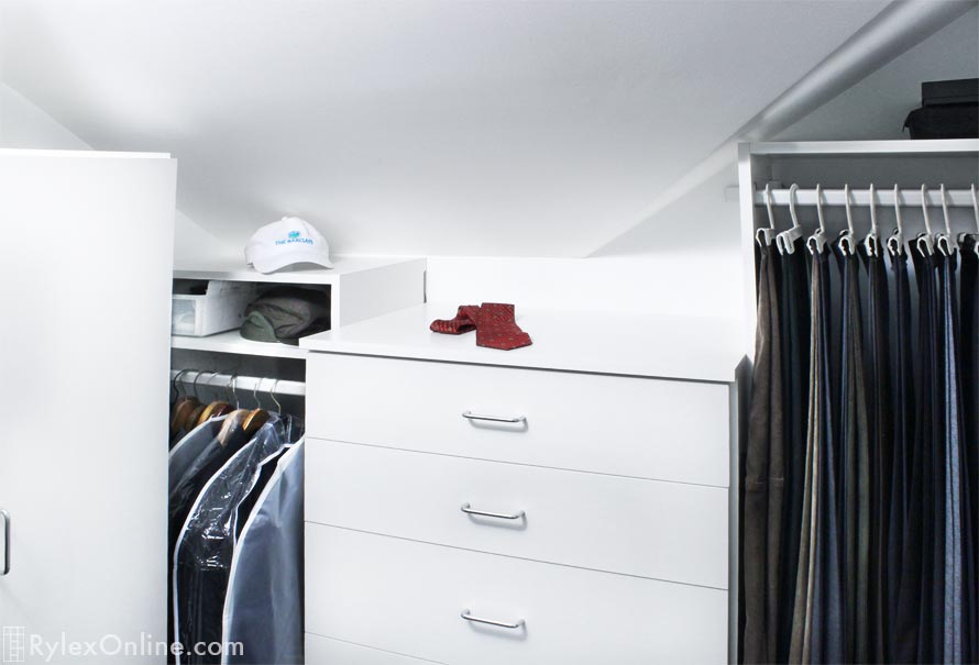 Sloped Ceiling Closet Design with Cabinet Drawers and Trouser Hanging Space