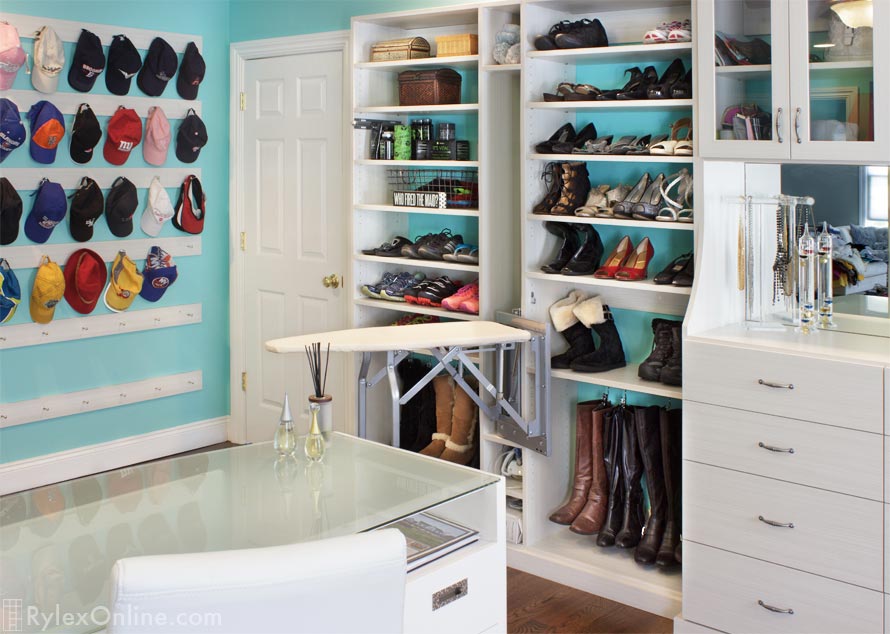 Closet with Ironing Board and Hanging Boot Storage and Cap Rack