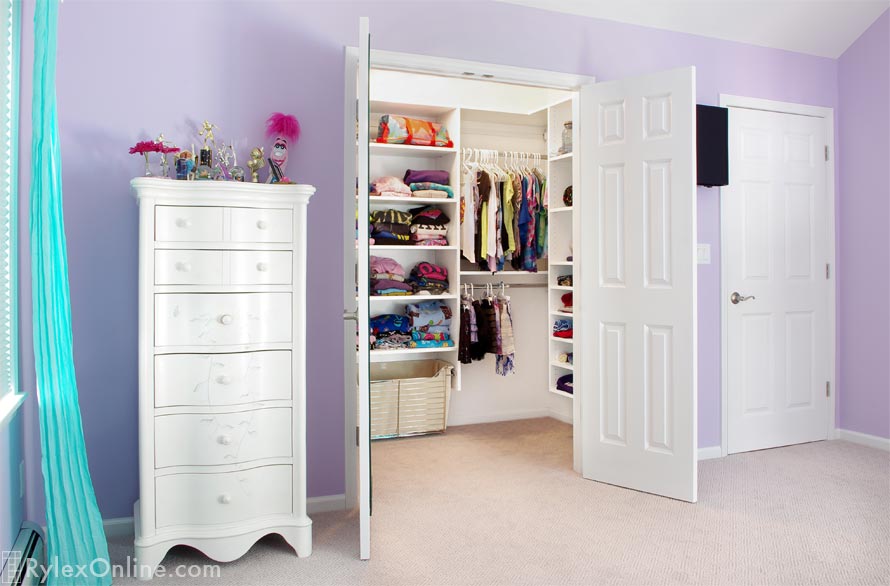 Girl's White Walk-in Closet with Adjustable Shelves and Sliding Hamper