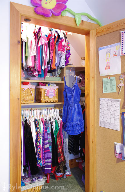 Girl's Closet with Hanging Rods and Open Shelves