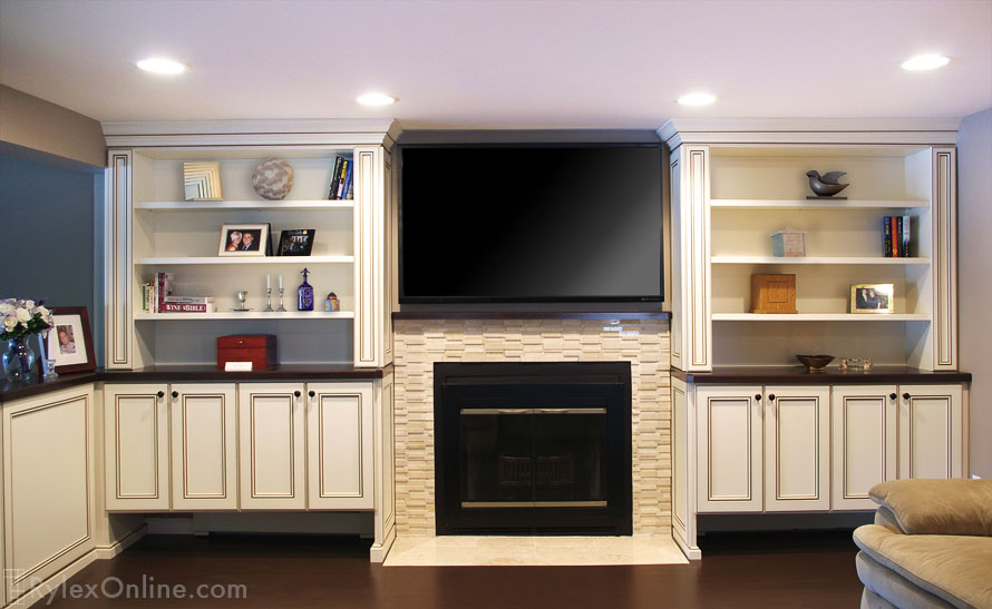Built-in Cabinets with Slim Profile End Cabinets and Display Shelves Surround Fireplace and Big Screen TV