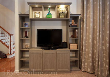 Warm Toned Family Room Entertainment Center with Open Display Shelves