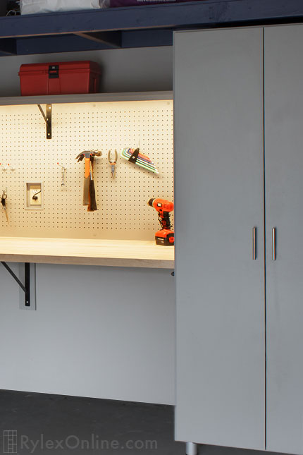 Garage Cabinet with LED Lighting on Tool Pegboard, Wood Countertop Close Up