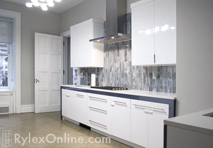 White Glossy Cabinets with Polished Metal Pull Bars