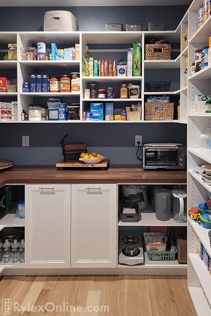 Butcher Block Counter with Pantry Cabinets and Open Shelves