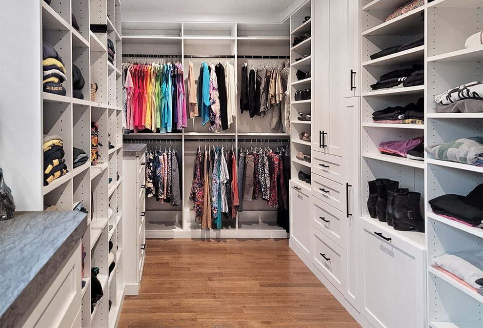 Primary Closet with Cabinets and Adjustable Shevles