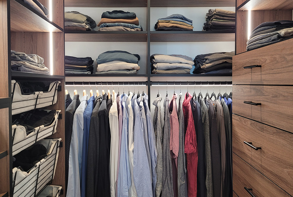 Dramatic Lighting for Men's Closet with Open Shelves and Sliding Baskets