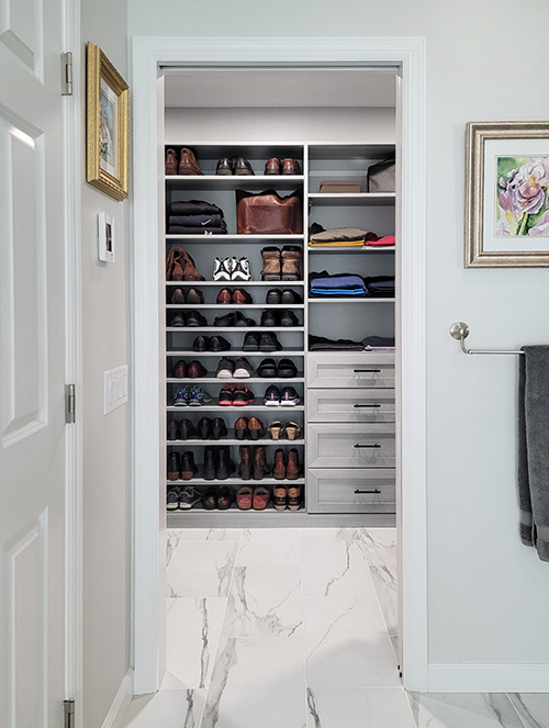 Primary Closet with Flat Adjustable Shoe Shevles and Drawers