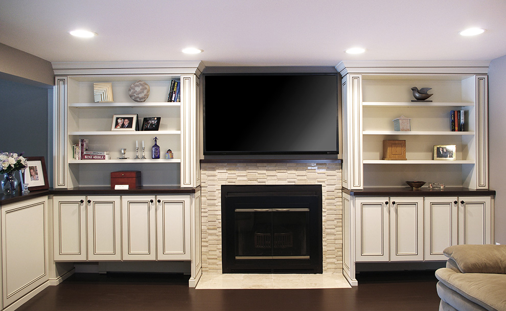 Built-in Cabinets with Slim Profile End Cabinets and Display Shelves Surround Fireplace and Big Screen TV