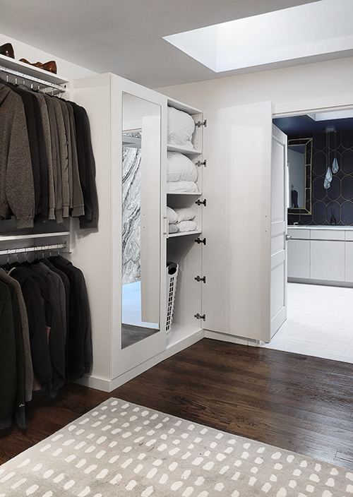 Primary Custom Walk-In Closet with Mirrored Linen Cabinet