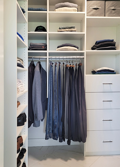 Custom Primary Walk-In Closet with Open Shelving, Custom Drawers, Adjustable Shelving and Hanging Space