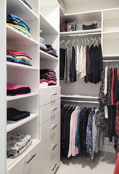 Primary Walk-In Closet with Laundry Hamper, Built-In Drawers, Adjustable Shelves and Hanging Space