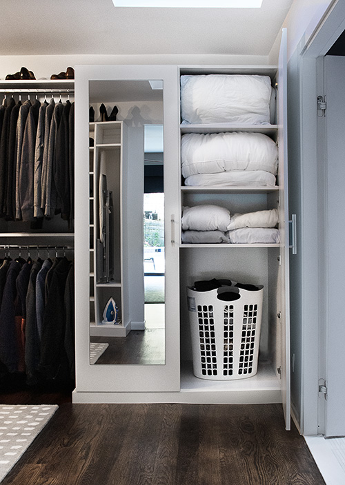 Primary Walk-In Closet with Built-In Mirrored Linen Cabinet