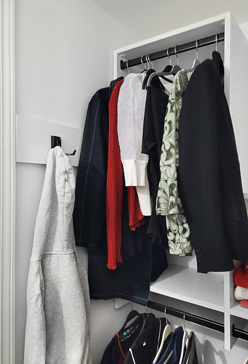 Angled Wall Closet with Adjustable Shelving and Coat Hooks