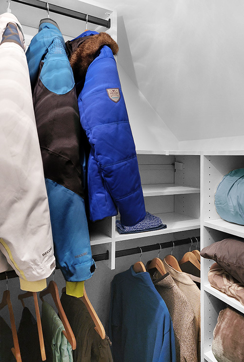 Angled Ceiling Walk-in Winter Storage Closet with Hanging Storage and Adjustable Shelving
