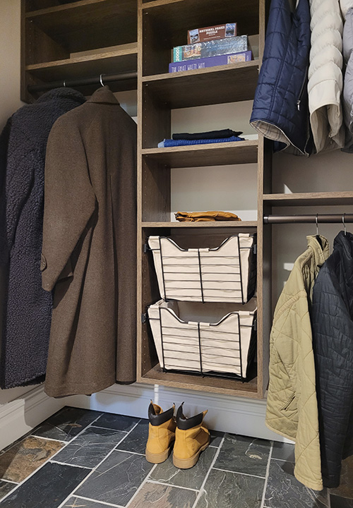 Well-Designed Entry Closet with Hanging Space, Adjustable Shelves, Hanging Space and Canvas Lined Sliding Baskets