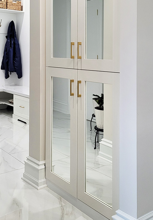 Close On Cabinet Mirrored Doors with Gold Hardware