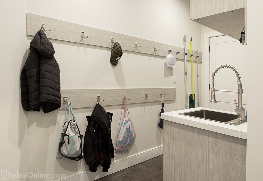 Mudroom Hooks Organize an Expansive Wall for Mops, Coats, Back Packs