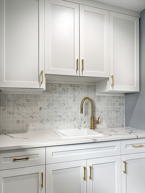 Laundry Room White Cabinets with Gold Hardware