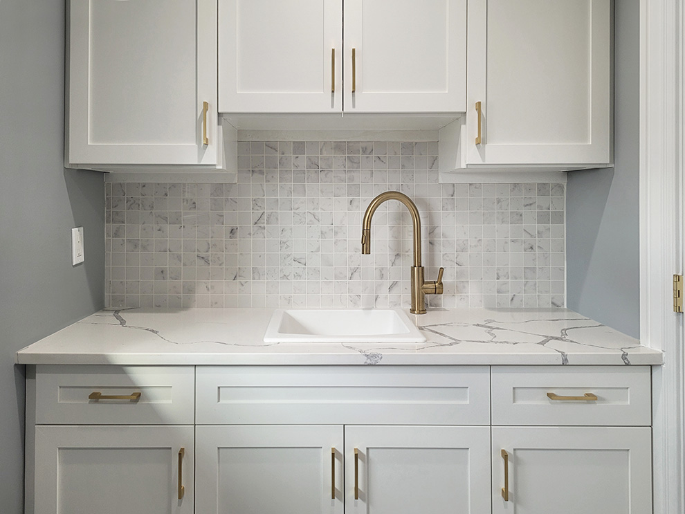 White Laundry Room Cabinets with Gold Hardware