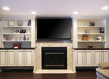 Custom Fireplace Bookcases and Cabinets Surround a Fireplace