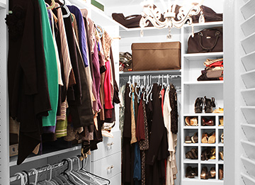 Walk-In Closet with Garment Rods, Shoe Cubbies and Dual Hamper Drawer